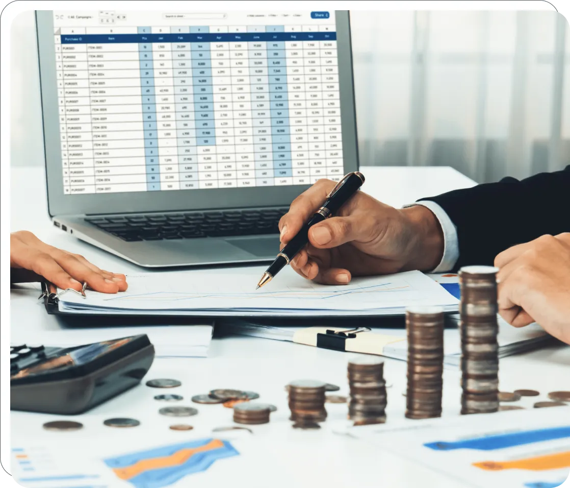Business meeting with laptop and stacked coins.